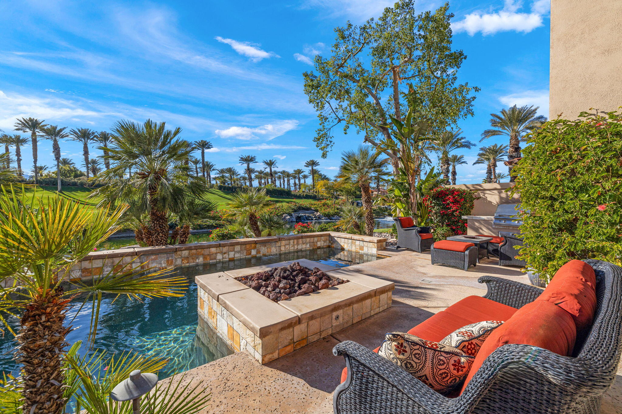 a view of a backyard with plants and outdoor seating