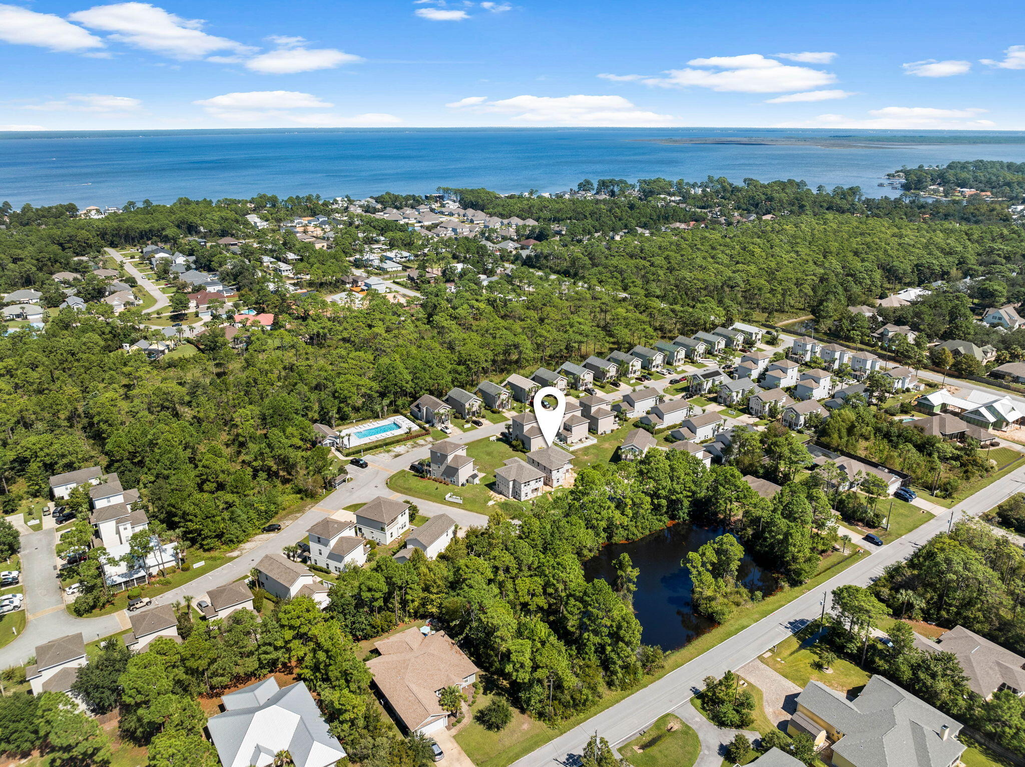 an aerial view of a residential houses with outdoor space