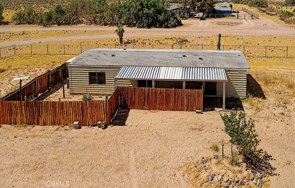 a view of a house with wooden fence