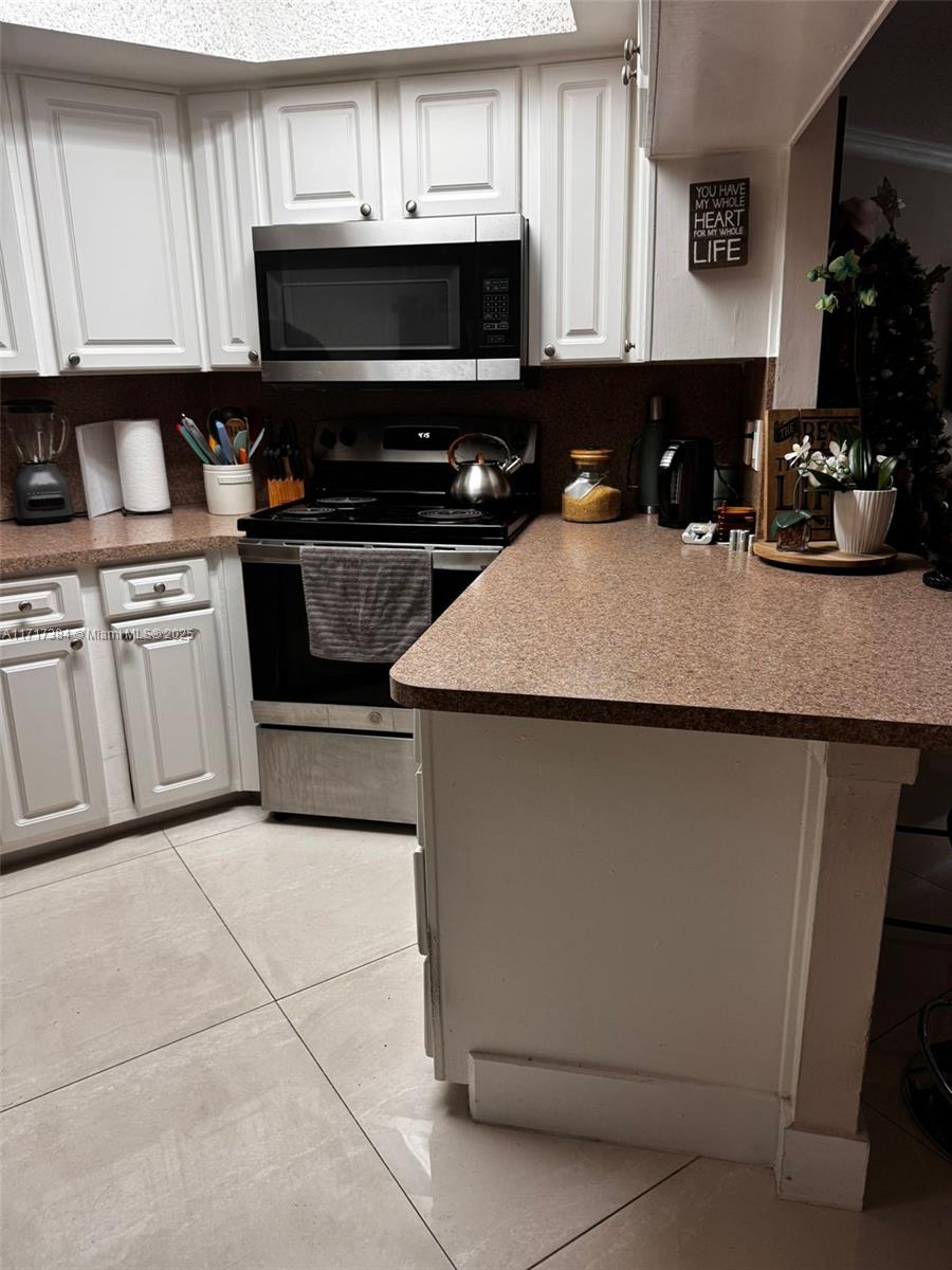 a kitchen with cabinets appliances and a sink