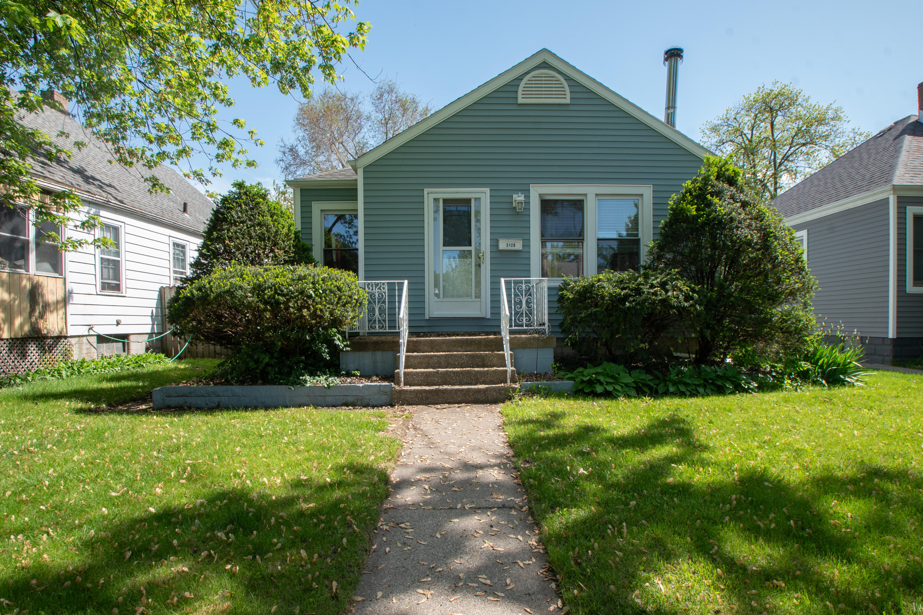 a front view of house with yard and green space