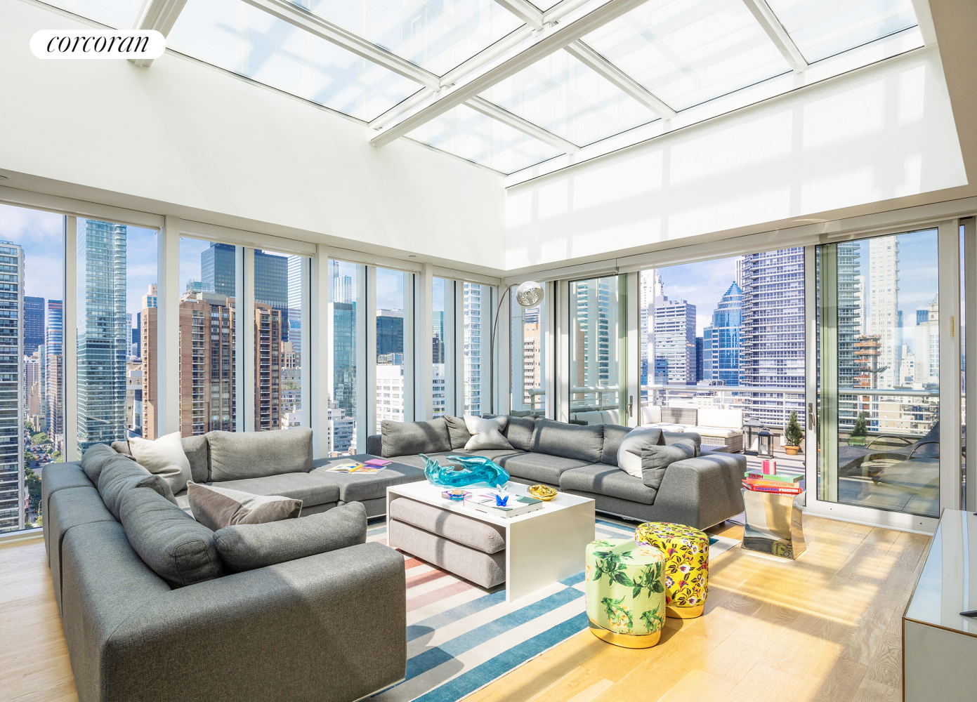 a living room with furniture and floor to ceiling windows