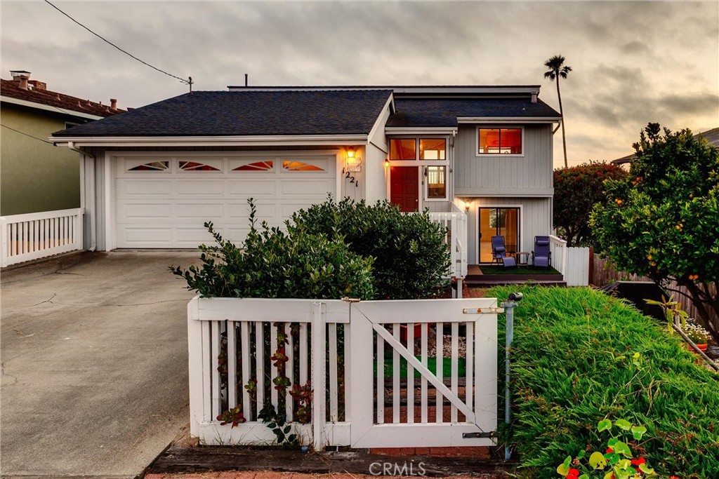 a view of a house with a small yard and plants