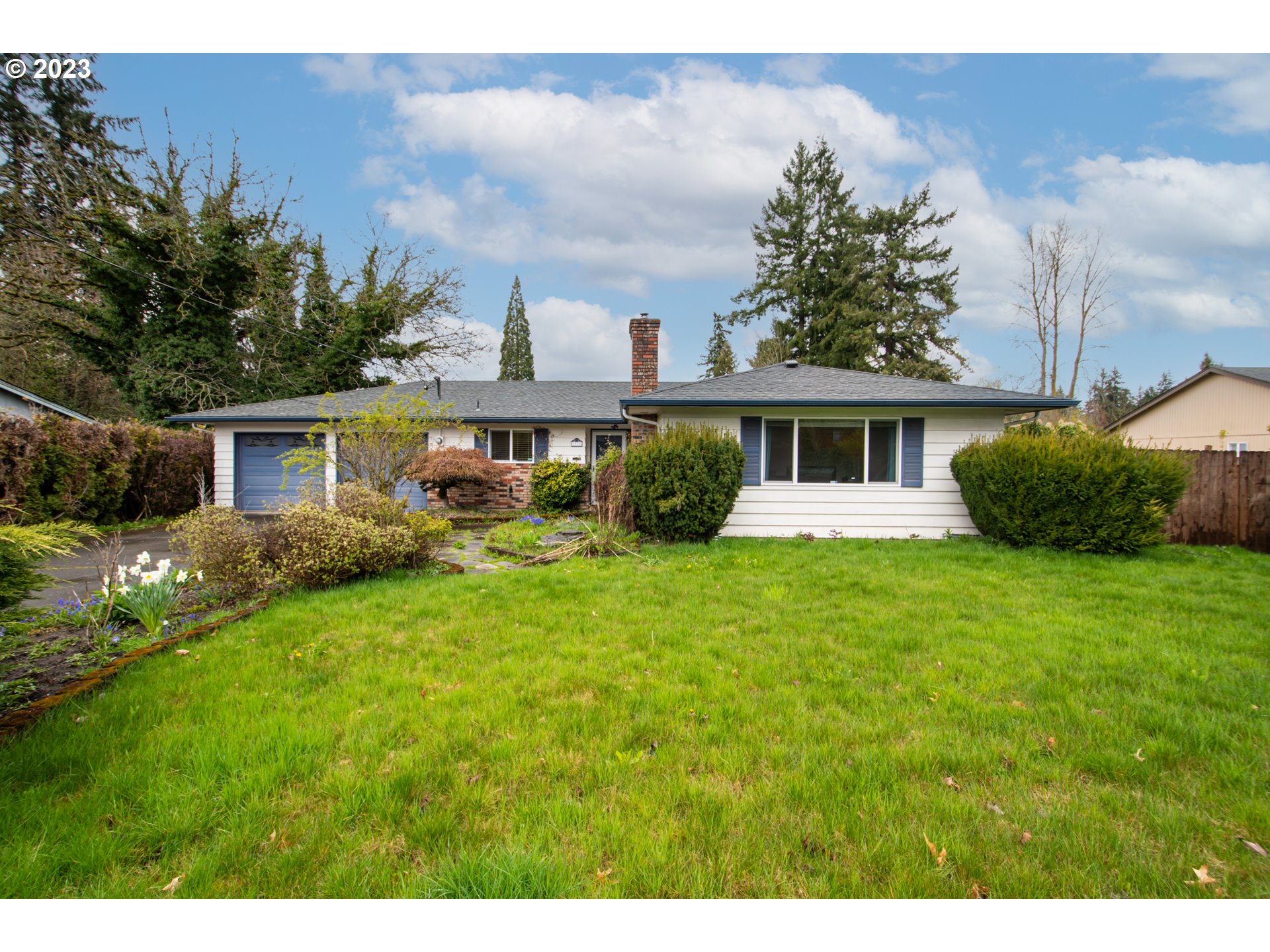 a front view of house with yard and green space