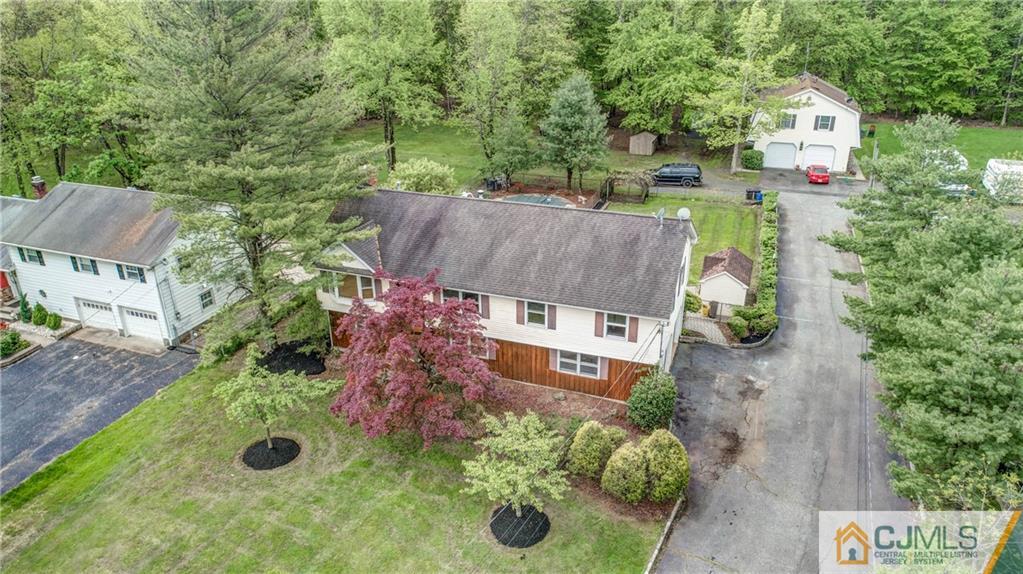 an aerial view of a house with yard