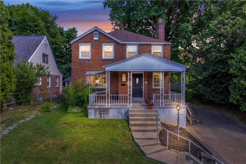 a front view of a house with yard porch and furniture