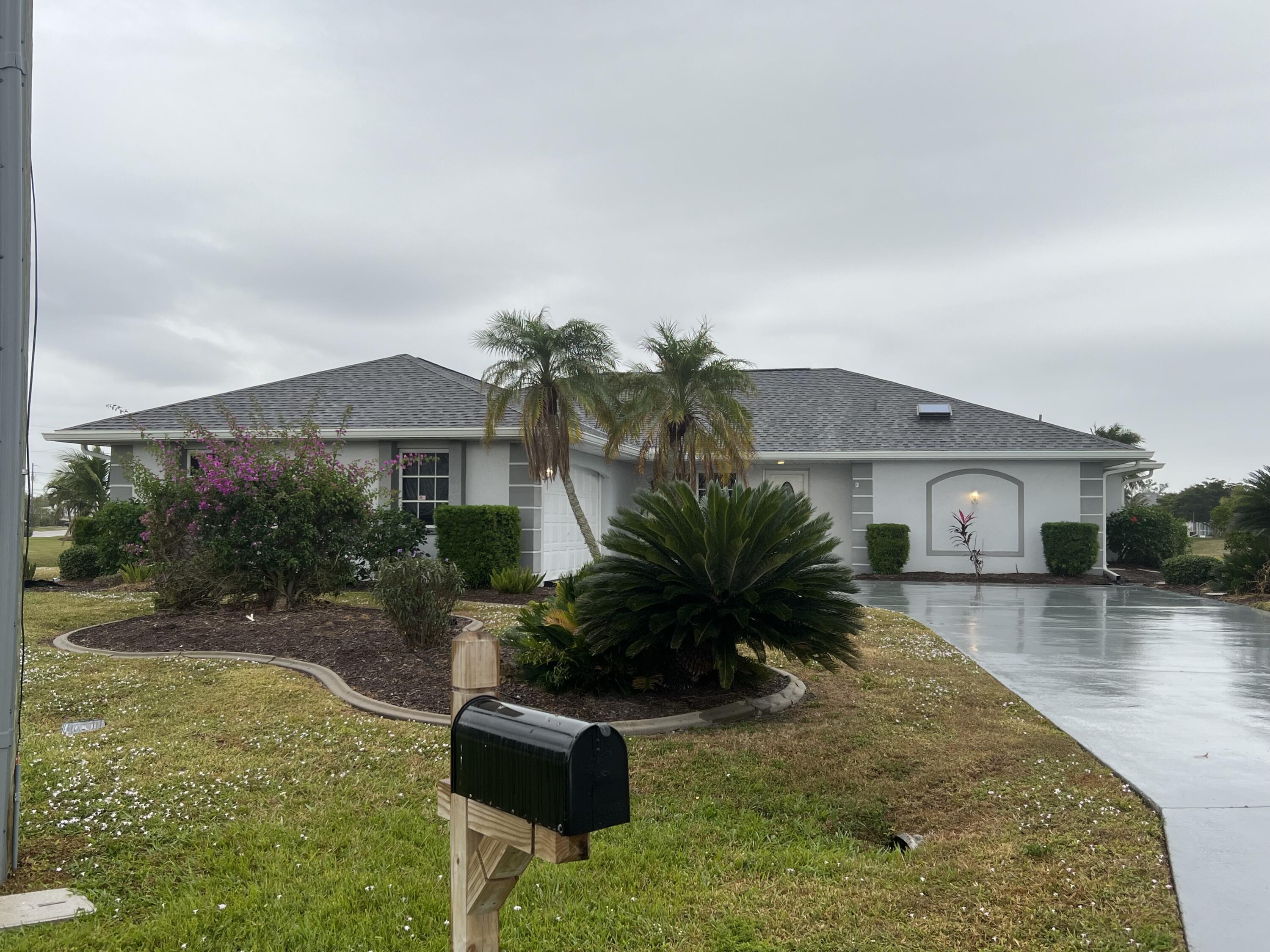 a front view of house with yard and outdoor seating