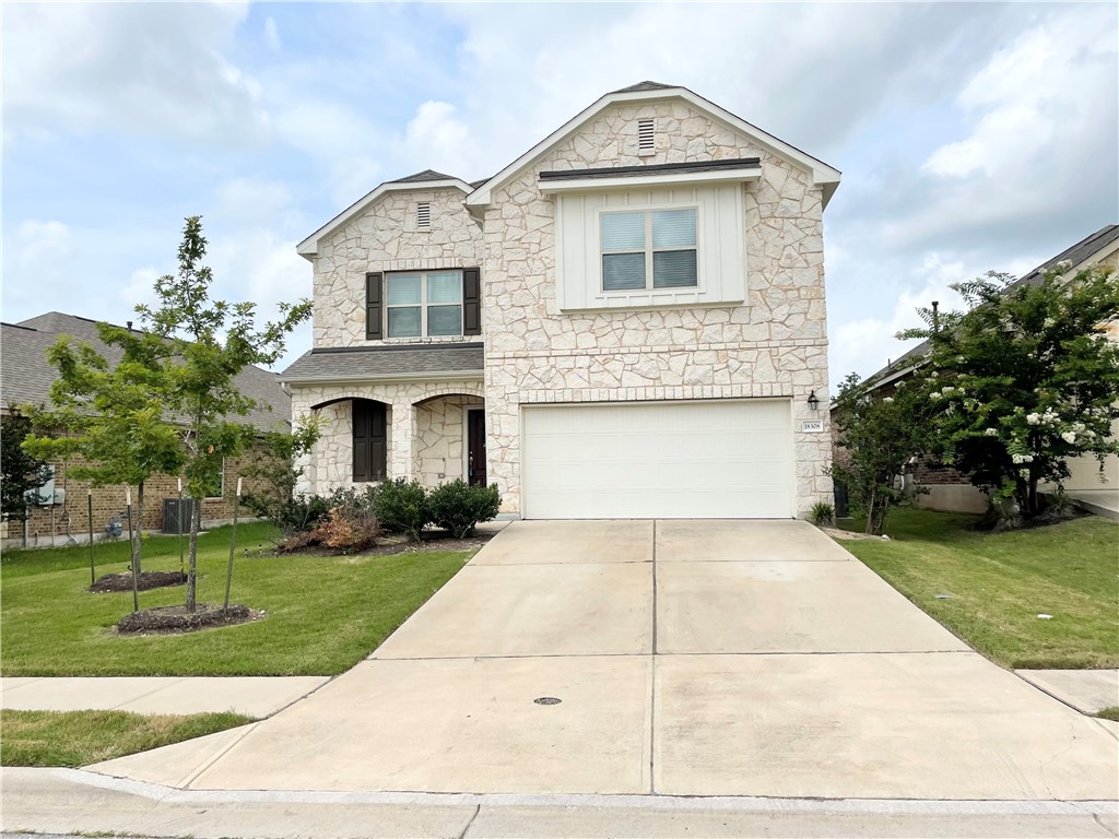 a front view of a house with a yard