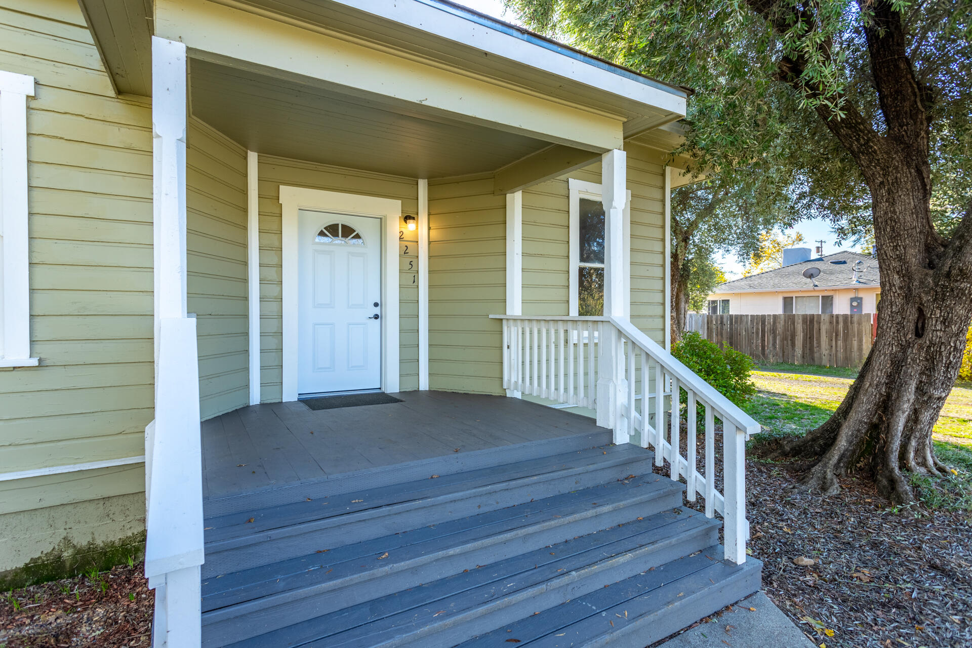 a view of a house with backyard and deck