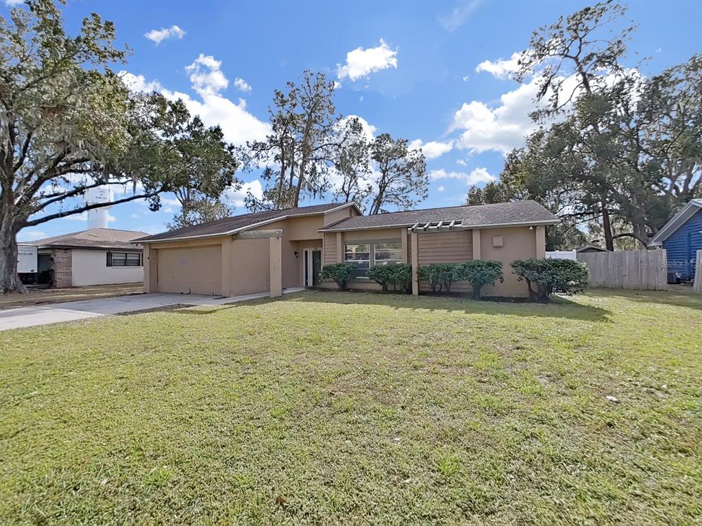 a front view of a house with a yard and a garage