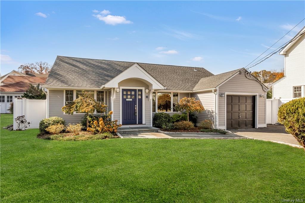 Ranch-style house featuring a front lawn and a garage