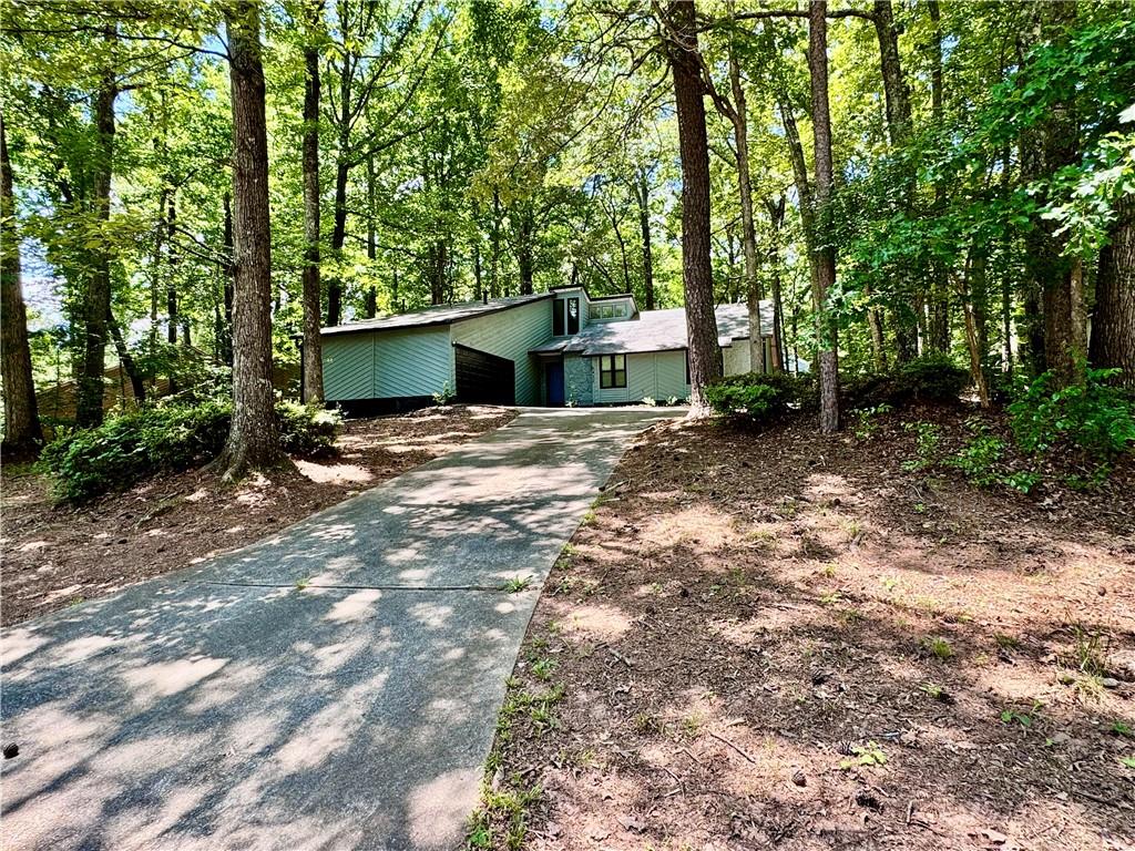 a view of a house with a yard and tree