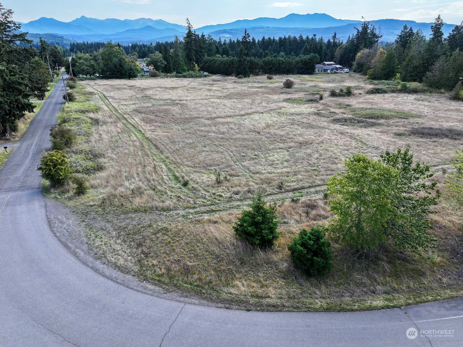 a view of a road with a field