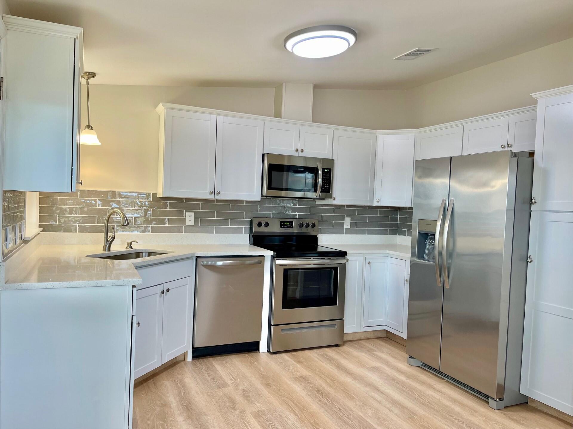 a kitchen with a sink stove and refrigerator