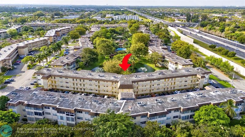 an aerial view of residential houses with outdoor space and swimming pool