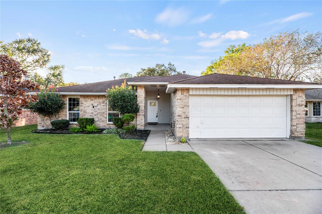 front view of a house with a yard and trees