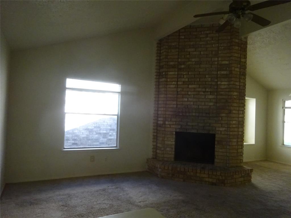 an empty room with a fireplace