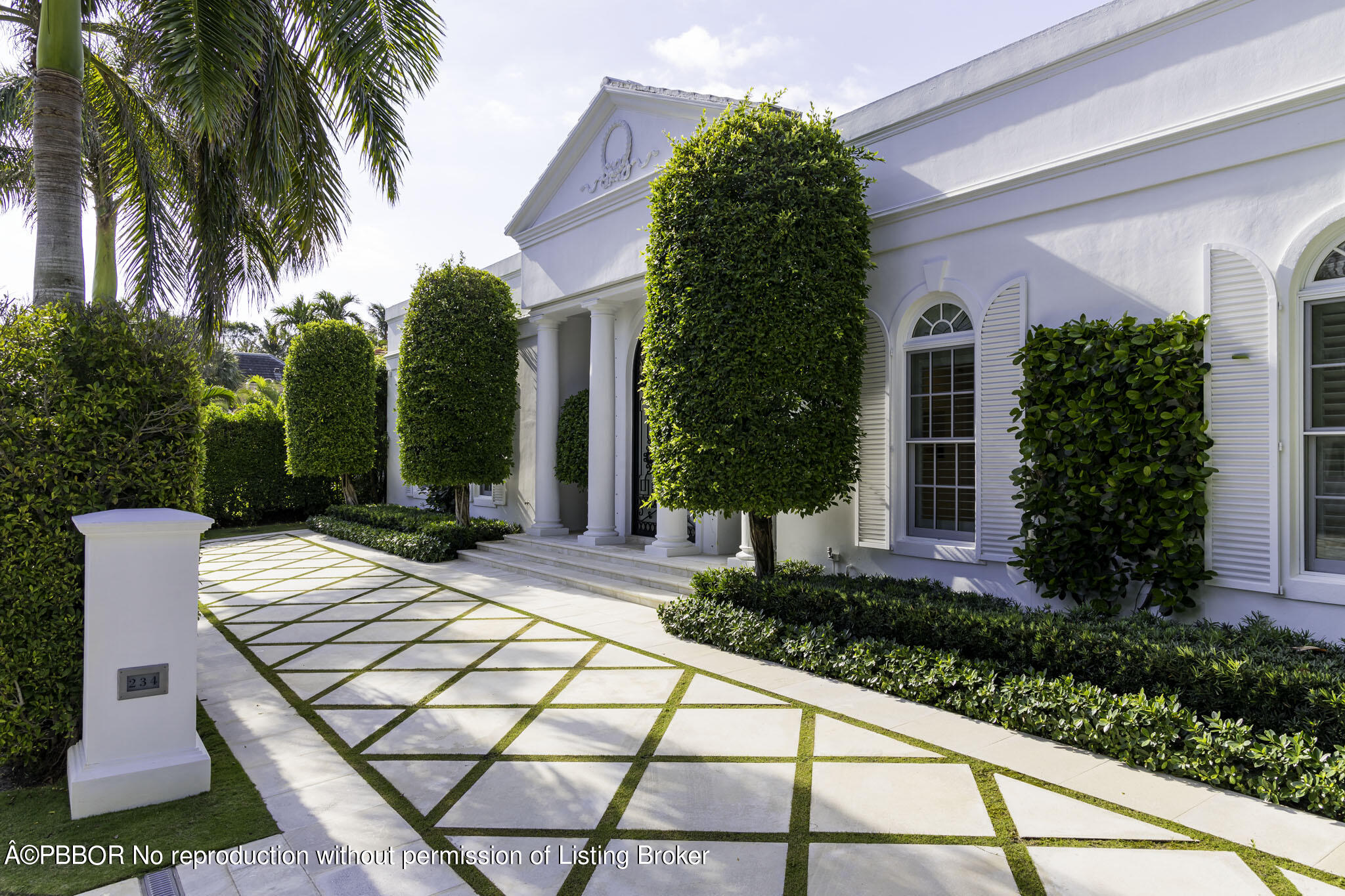 a view of a house with palm trees