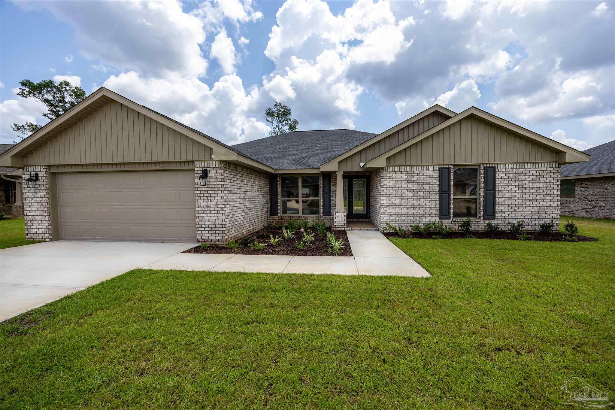 a front view of house with yard and garage