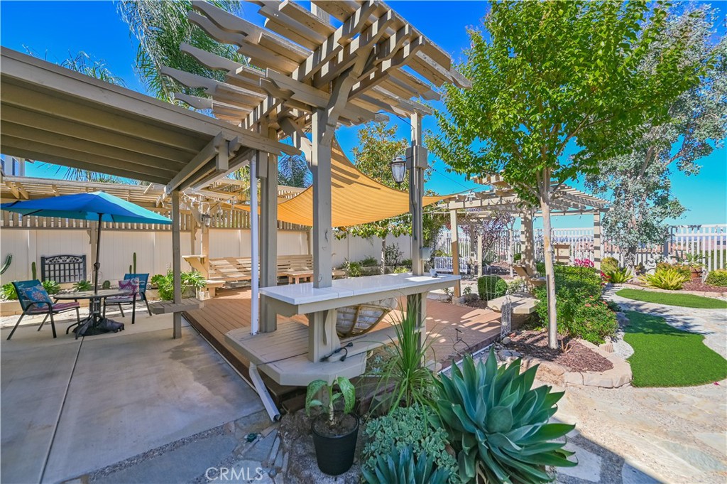 a view of a patio with chairs and potted plants