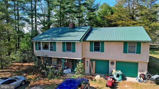 a aerial view of a house with table and chairs and a barbeque