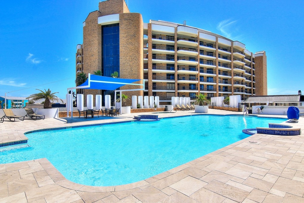 a view of a swimming pool with a lounge chairs