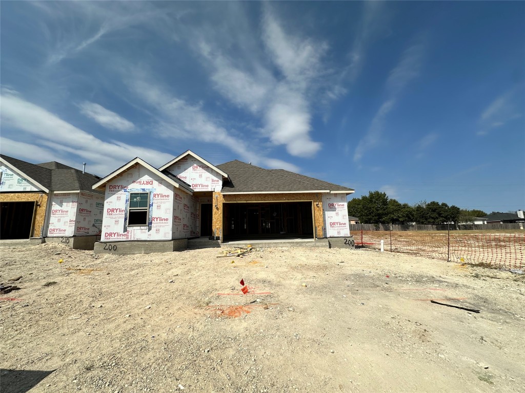 a view of house with yard and lake view