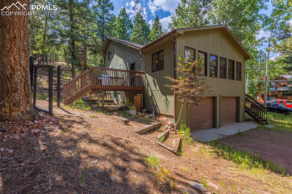 View of side of property with a garage and a deck