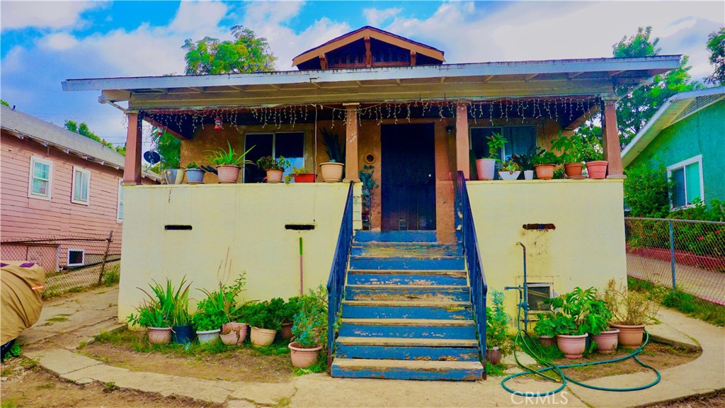 a front view of a house with a porch and a table