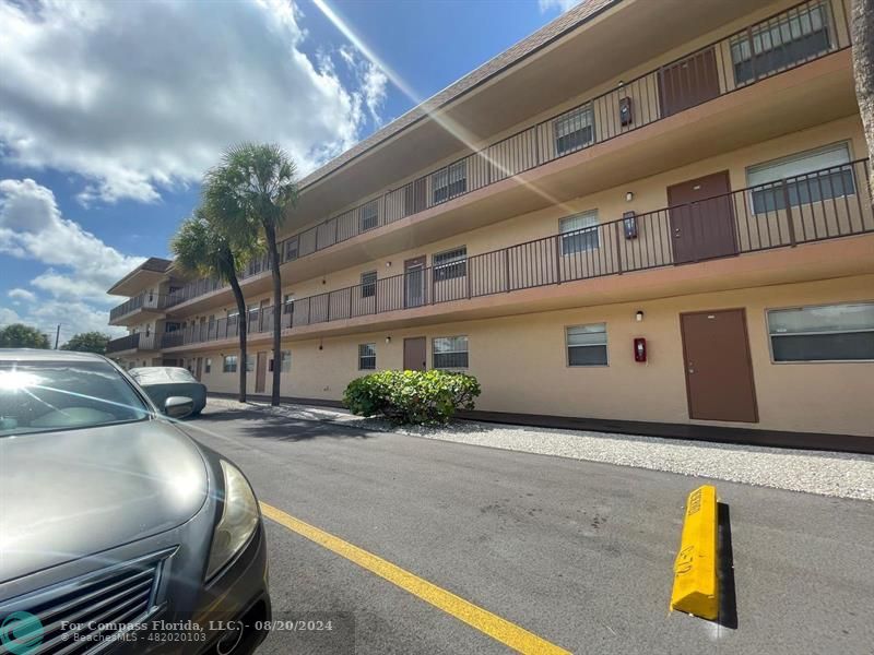 a view of a building with car parked