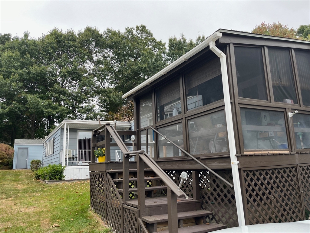 a front view of house with deck and outdoor seating