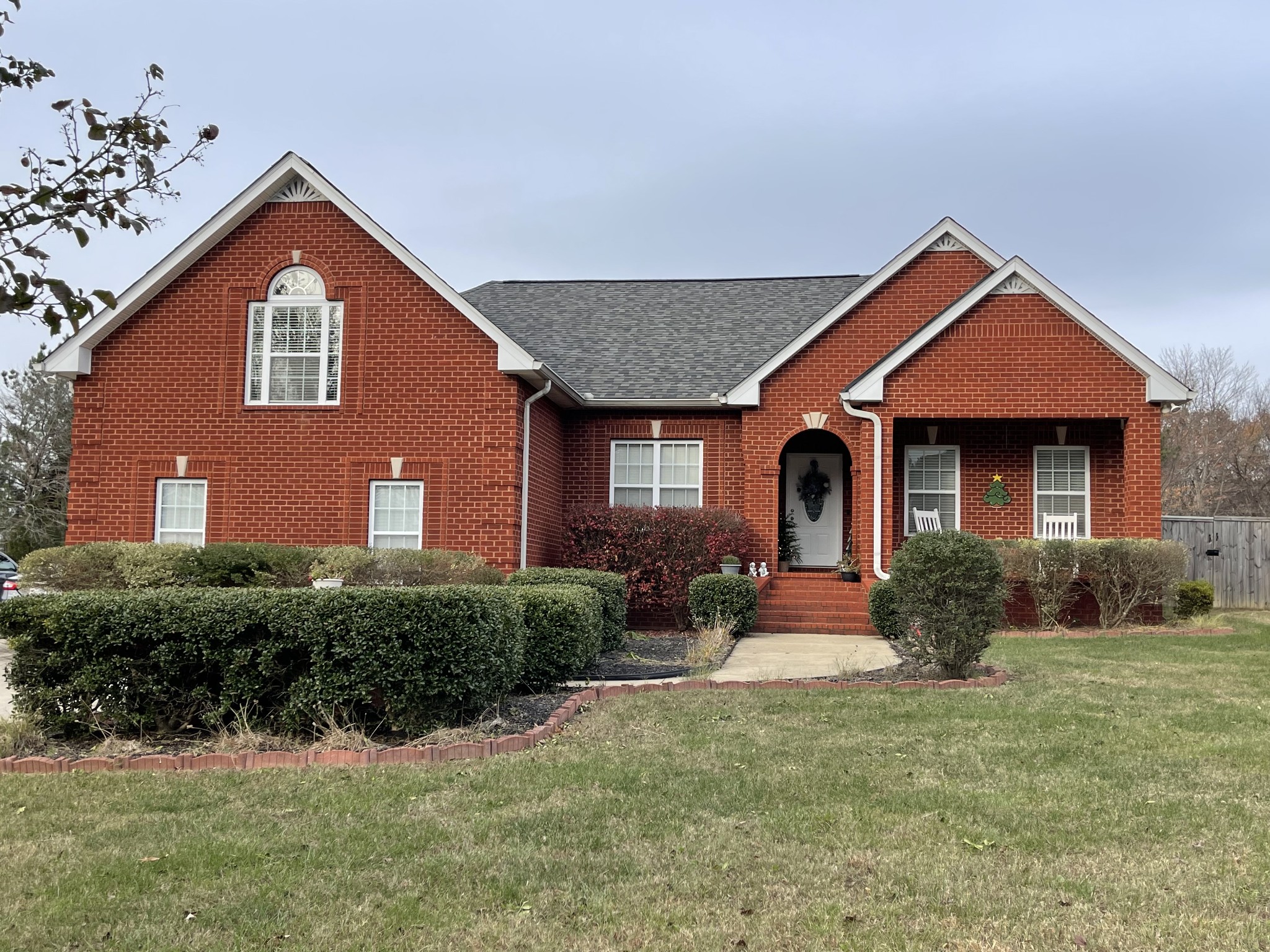 a front view of a house with yard and green space