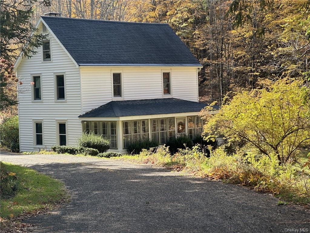 a front view of a house with a yard covered in snow