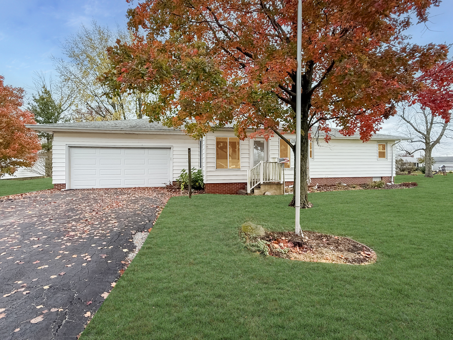 a view of a house with a yard and tree