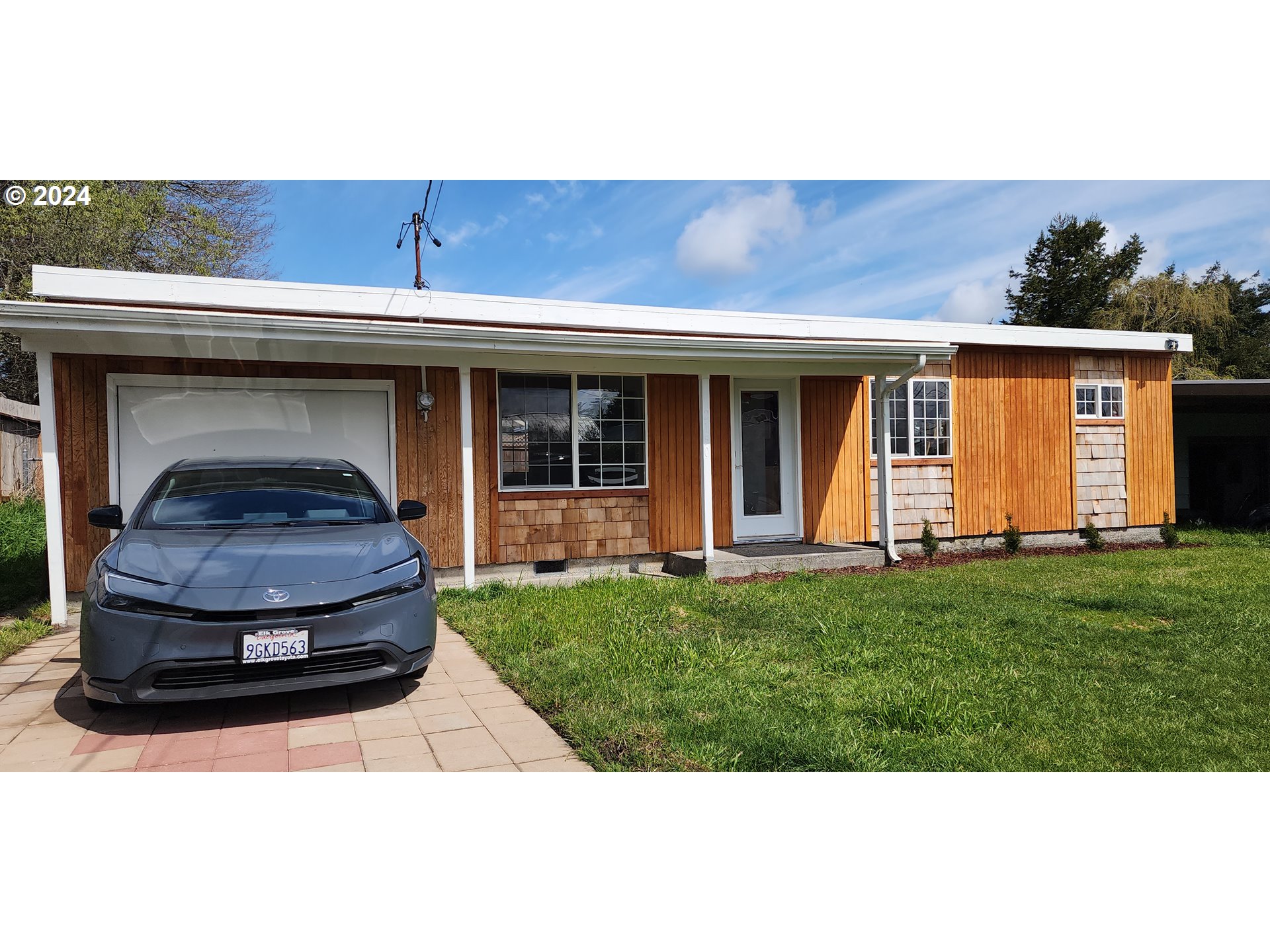 a front view of a house with a yard