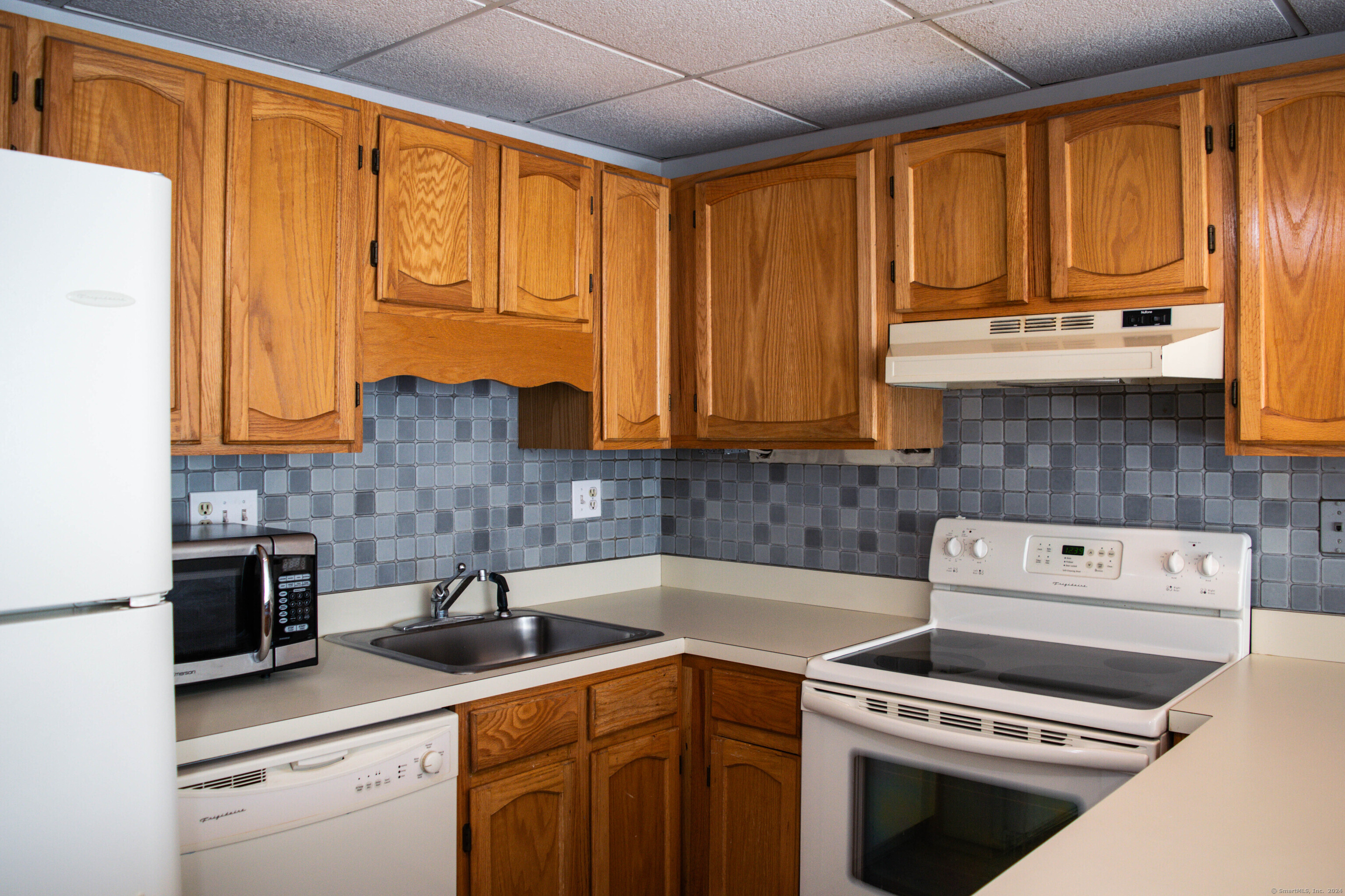 a kitchen with stainless steel appliances a stove sink and cabinets