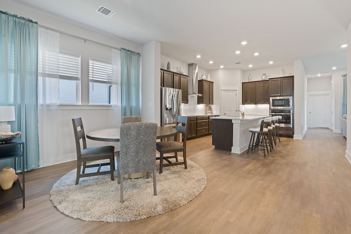 A spacious open floor plan seamlessly connects the dining area and kitchen to the living space, creating an ideal environment for entertainment and everyday living.