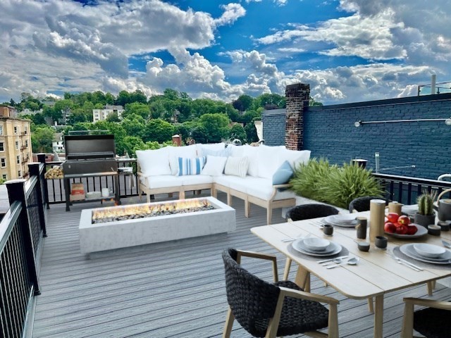 a view of a patio with couches table and chairs and potted plants