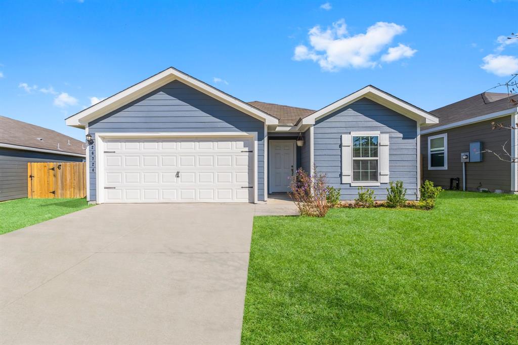 a front view of house with yard and green space