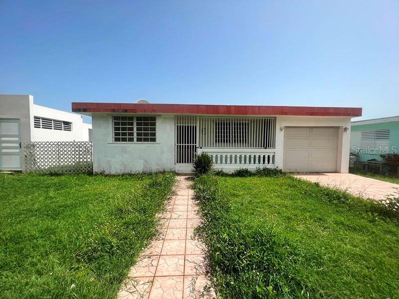 a front view of a house with a garden