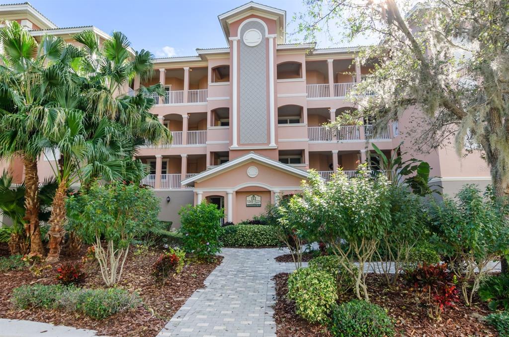 a front view of a residential apartment building with a yard