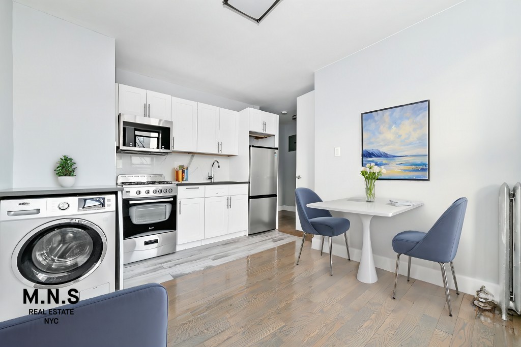 a view of kitchen and sink with wooden floor