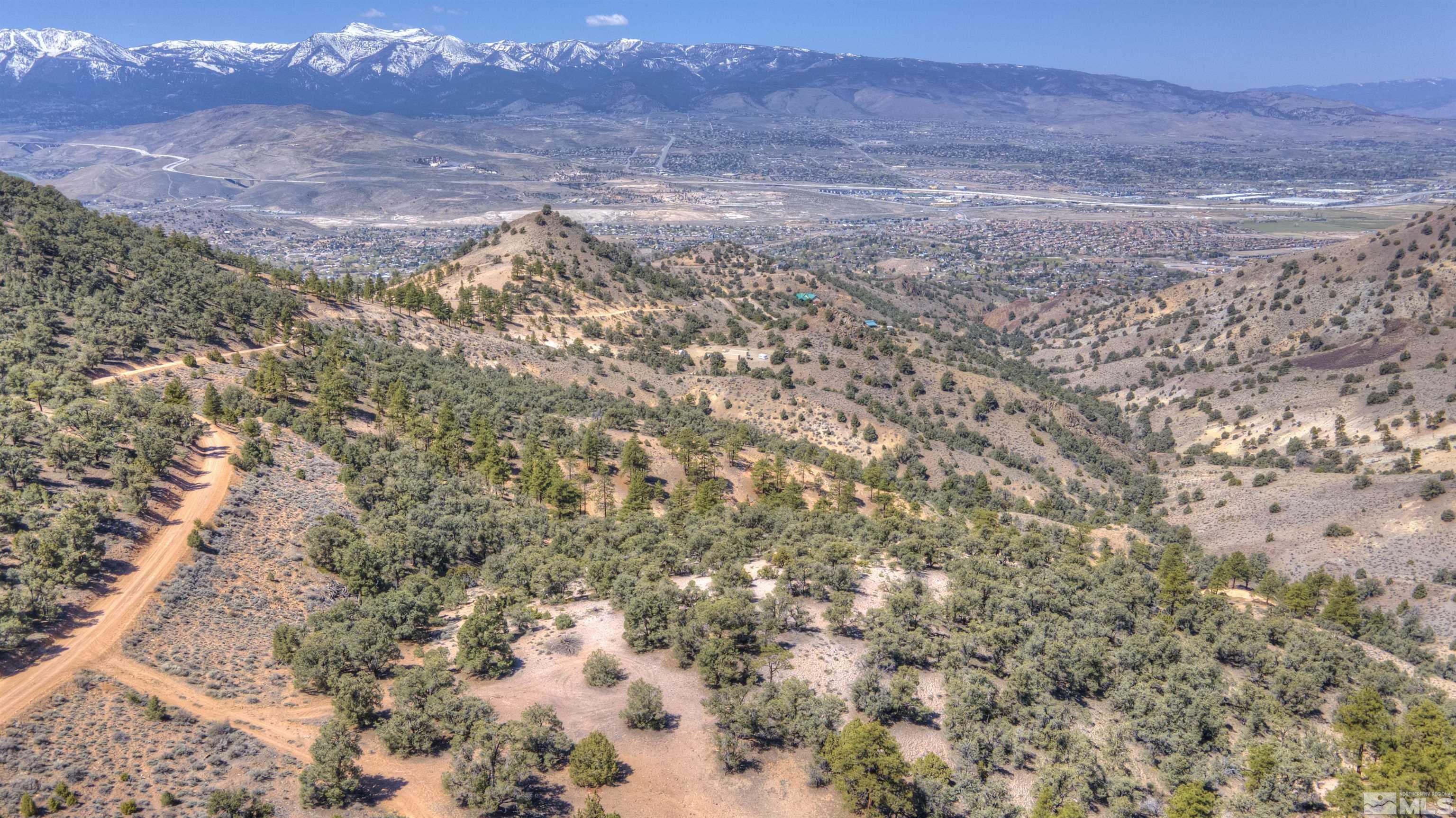 a view of a dry yard with mountains in the background