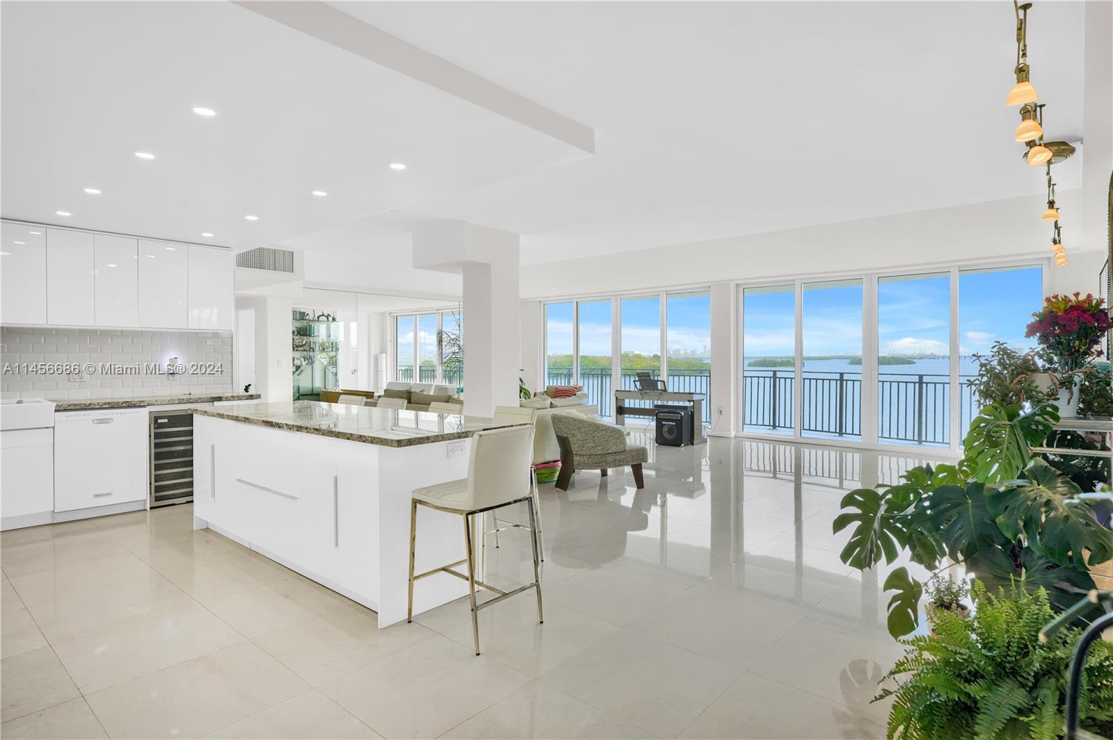 a kitchen with white cabinets and counter space