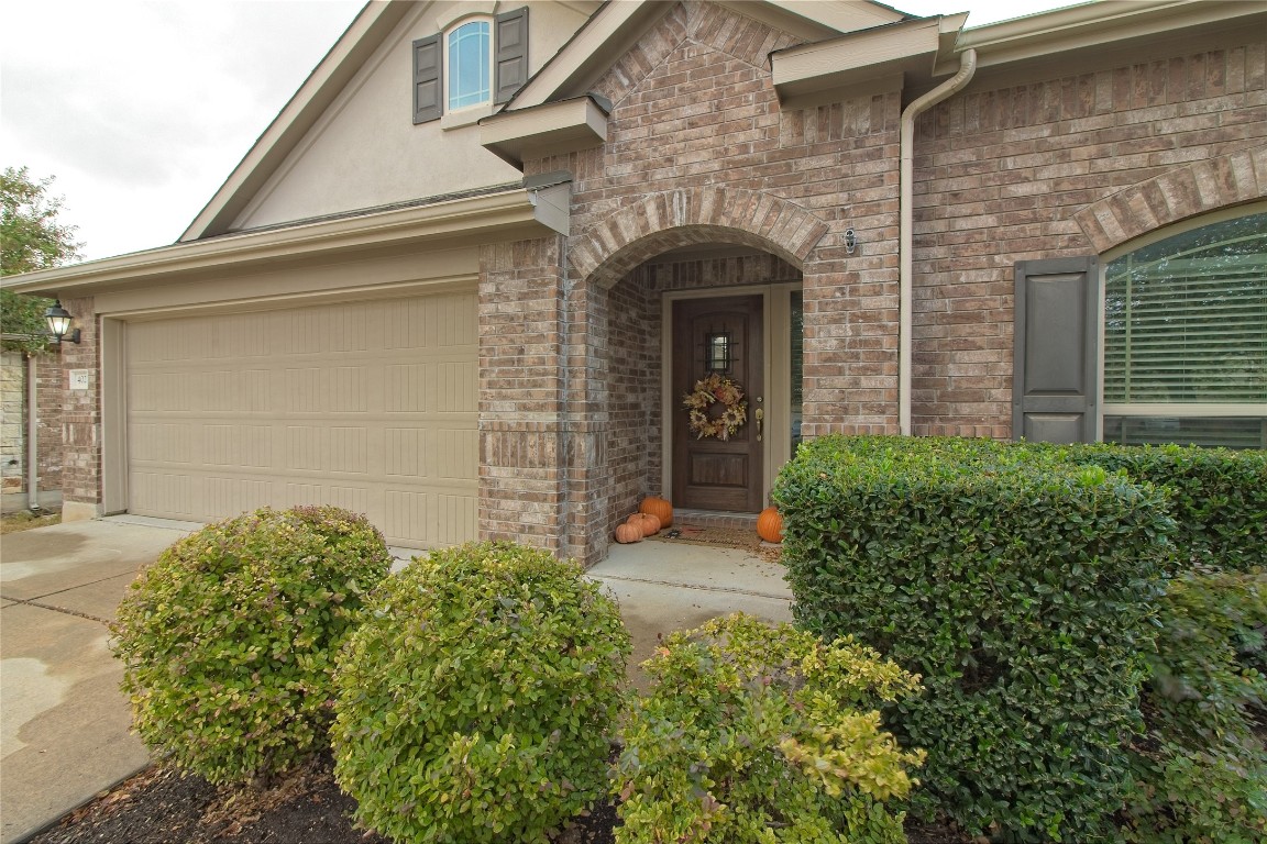 front view of a house with potted plants