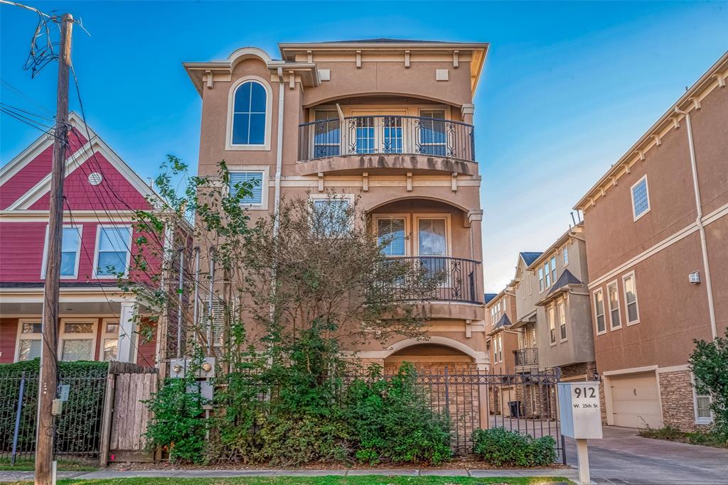 a front view of a residential apartment building with a yard