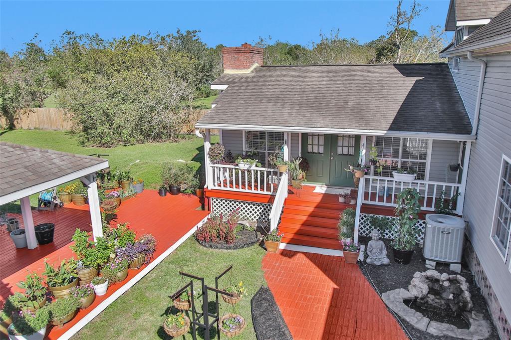 an aerial view of a house with swimming pool lawn chairs and a yard