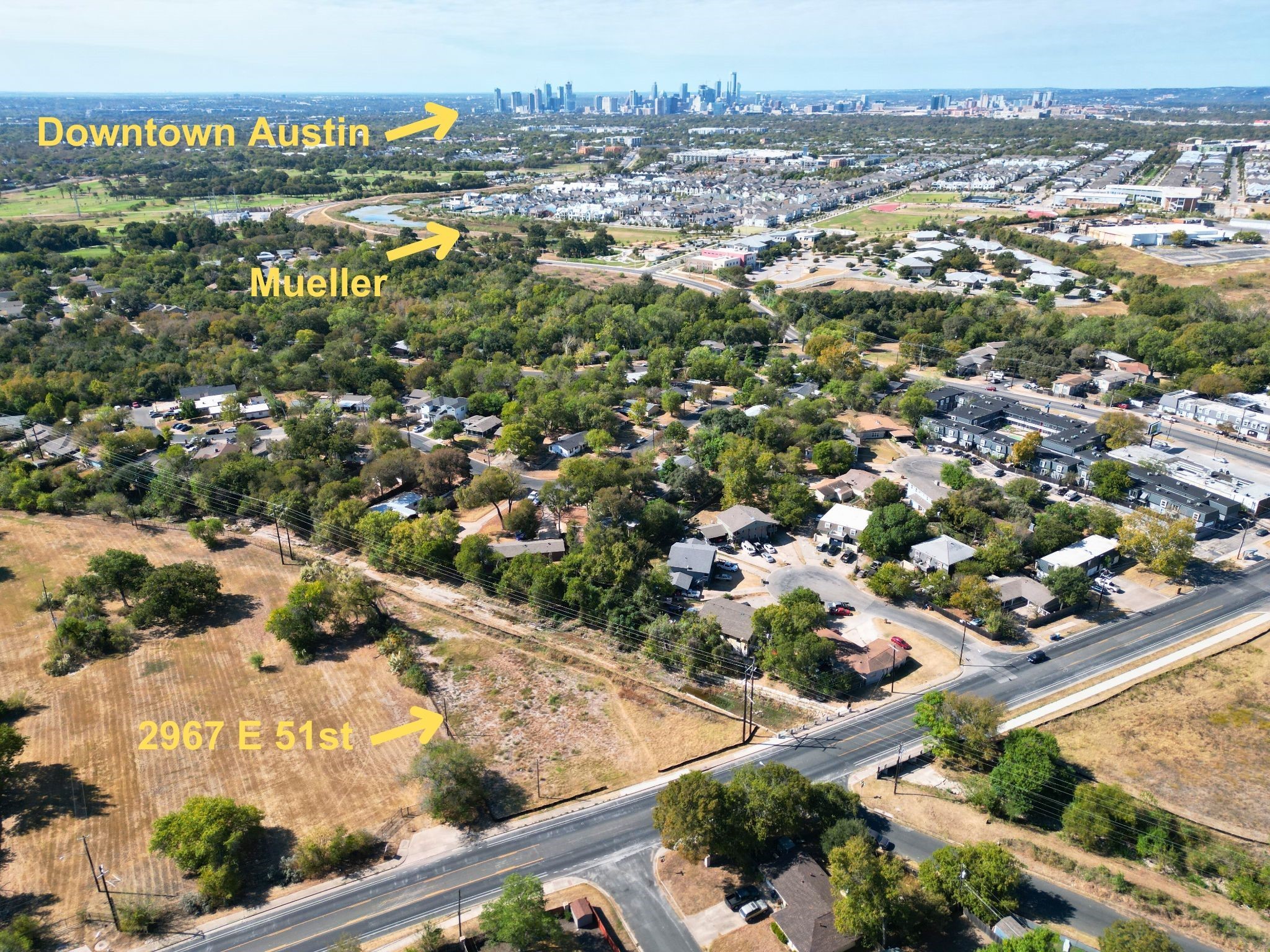 an aerial view of residential houses with outdoor space