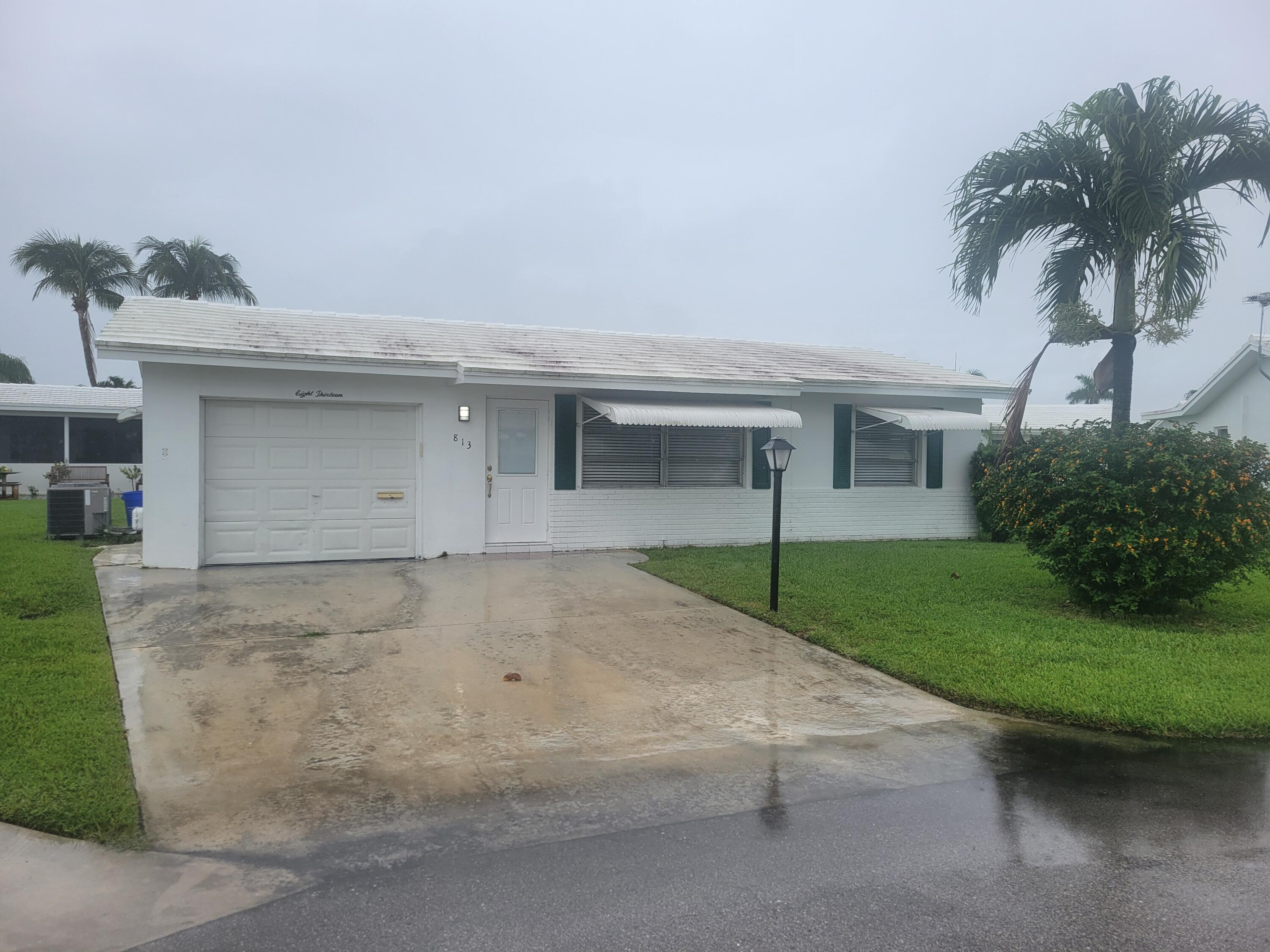 a house with a yard and a large parking space