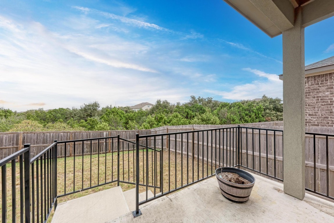 a view of roof deck with wooden fence and floor